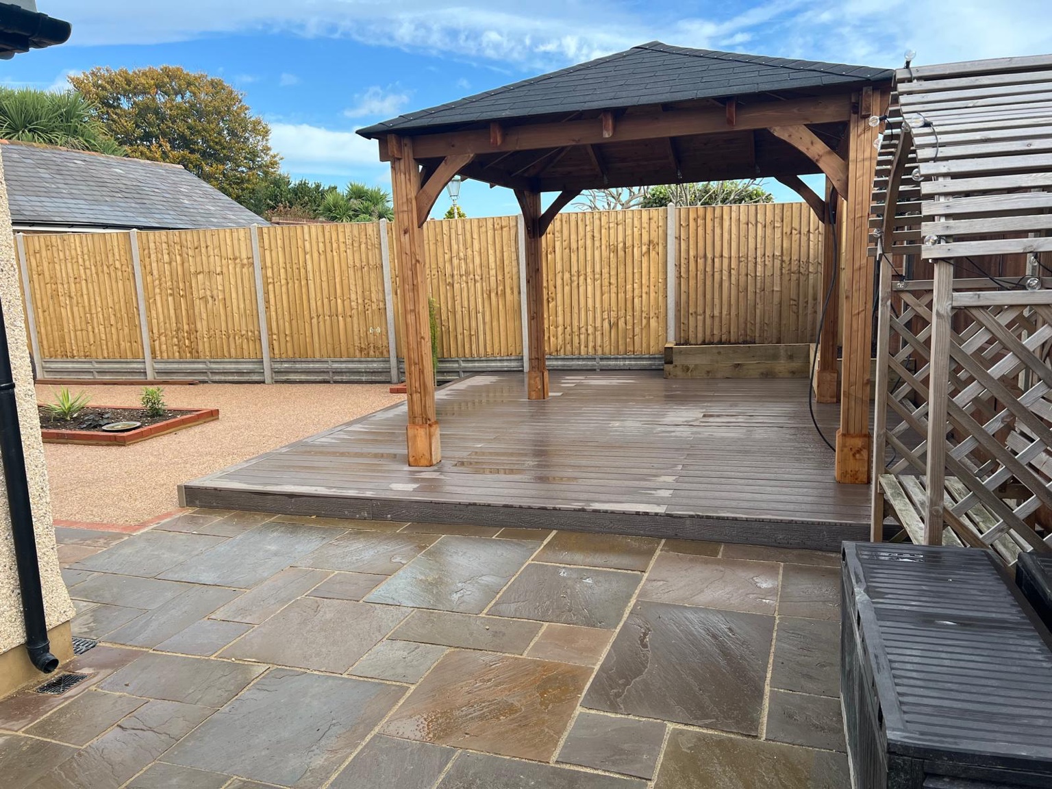 Ash-coloured composite deck beneath a timber pergola in Deal
